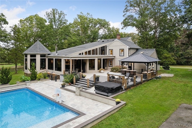 rear view of house with a patio, a gazebo, and a lawn