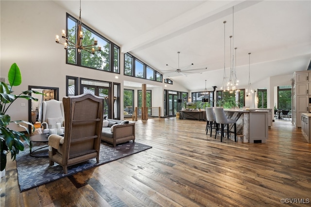 living room with dark hardwood / wood-style floors, high vaulted ceiling, and plenty of natural light