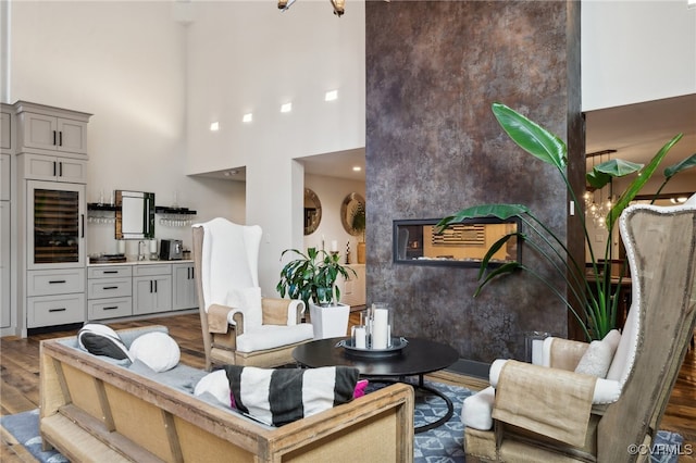 living room with a high ceiling and dark hardwood / wood-style floors