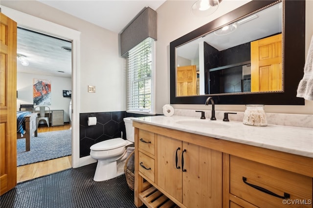 bathroom featuring vanity, an enclosed shower, hardwood / wood-style flooring, and toilet