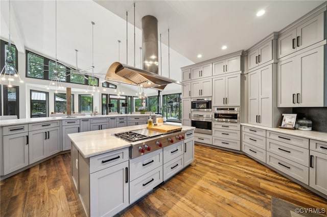 kitchen with stainless steel gas cooktop, a healthy amount of sunlight, and gray cabinetry