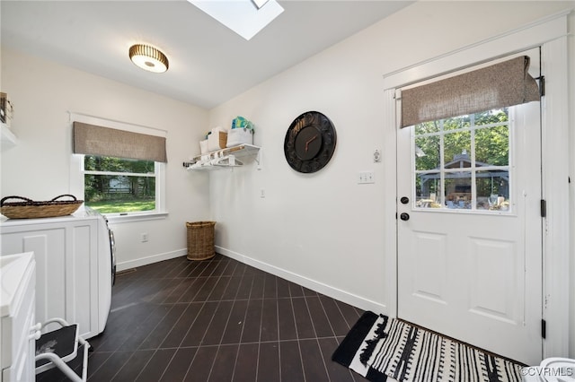 laundry area featuring a skylight and washer and clothes dryer