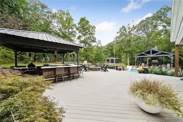 view of property's community featuring a gazebo and a wooden deck