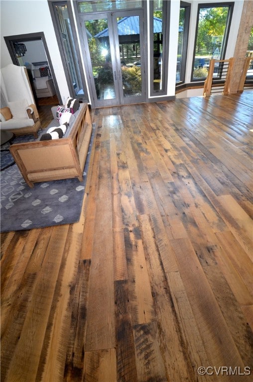 unfurnished living room featuring french doors and dark hardwood / wood-style flooring