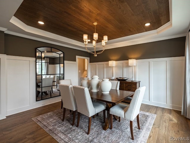 dining area featuring hardwood / wood-style floors, wood ceiling, crown molding, and a raised ceiling