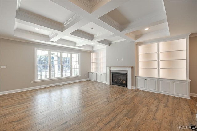 unfurnished living room with beamed ceiling, wood-type flooring, coffered ceiling, and built in features