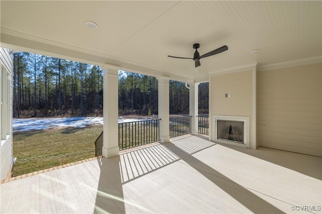 view of patio with ceiling fan and exterior fireplace