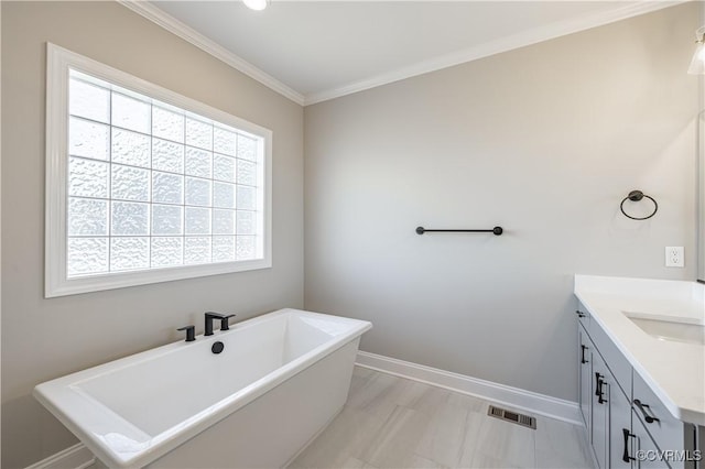 bathroom featuring vanity, a tub to relax in, and ornamental molding