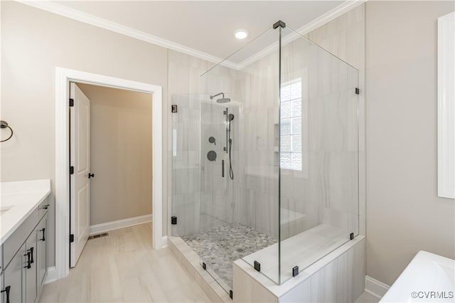 bathroom with ornamental molding, a shower with shower door, and vanity