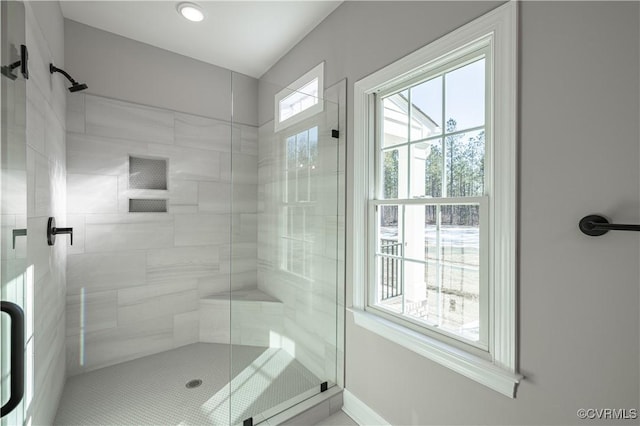 bathroom featuring a shower with shower door