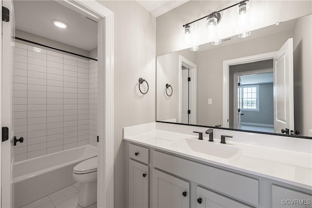 full bathroom featuring tiled shower / bath combo, vanity, tile patterned flooring, and toilet