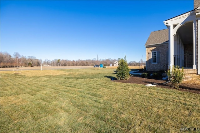 view of yard with a rural view