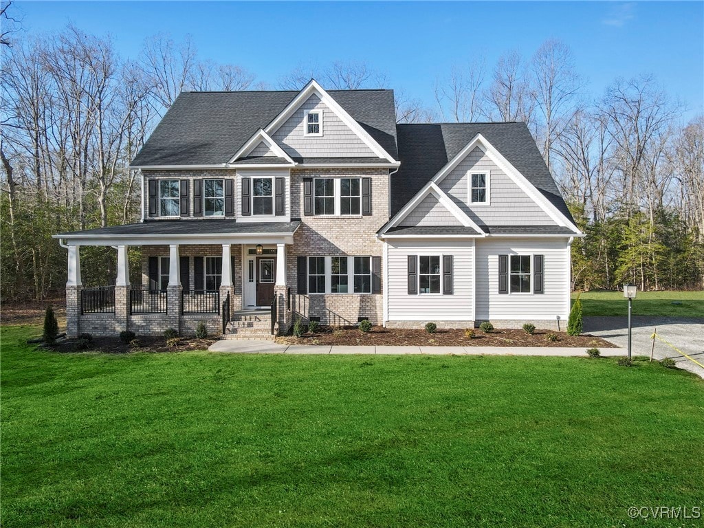 craftsman inspired home with a front yard and covered porch