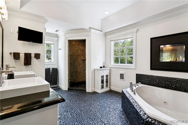 4048 Broad Street Rd, Gum Spring, VA 23065 - bathroom featuring baseboards, a jetted tub, double vanity, and crown molding