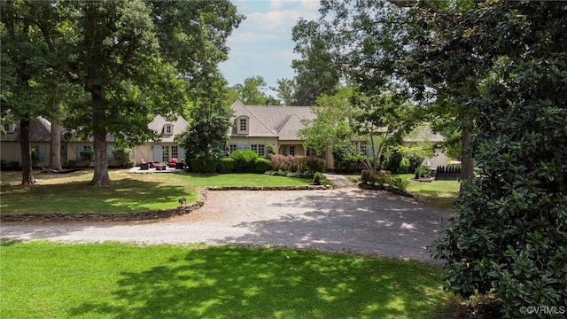 view of home's community with a yard