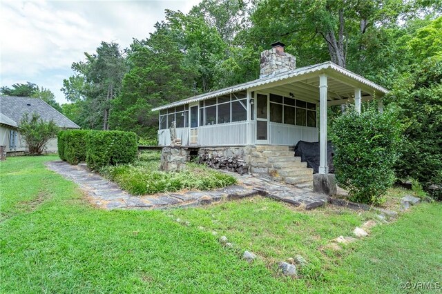 4048 Broad Street Rd, Gum Spring, VA 23065 - view of home's exterior with a sunroom, a chimney, and a lawn