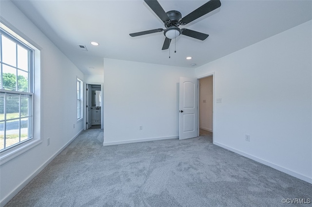 unfurnished bedroom featuring light carpet and ceiling fan