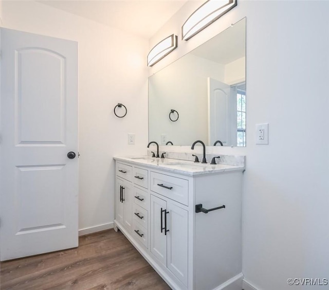 246 American Dr, Ruther Glen, VA 22546 - bathroom featuring double vanity and wood finished floors