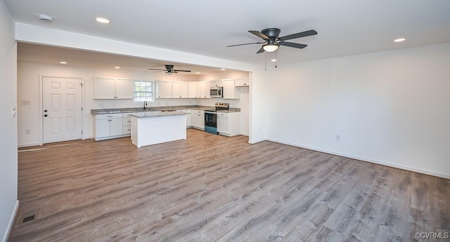 246 American Dr, Ruther Glen, VA 22546 - kitchen featuring appliances with stainless steel finishes, a ceiling fan, white cabinetry, light wood finished floors, and recessed lighting