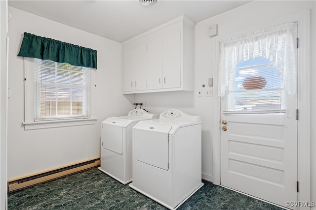 laundry room featuring washing machine and dryer, cabinets, and a baseboard radiator