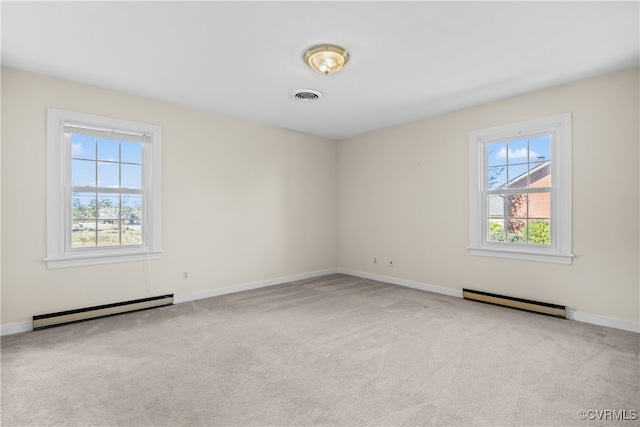 empty room with plenty of natural light, baseboard heating, and light carpet