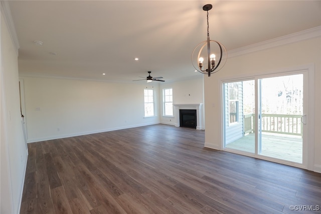 unfurnished living room with ornamental molding, ceiling fan with notable chandelier, and dark hardwood / wood-style flooring