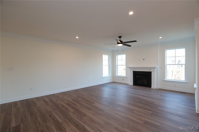 unfurnished living room featuring ceiling fan, crown molding, and dark hardwood / wood-style flooring