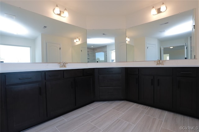 bathroom featuring walk in shower and vanity