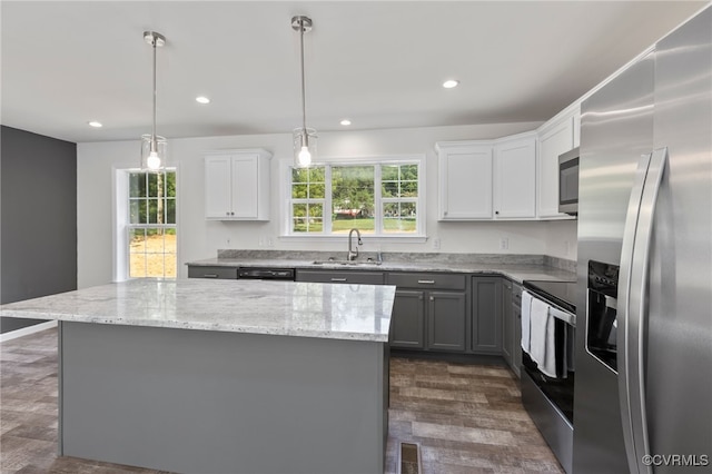 kitchen with white cabinets, appliances with stainless steel finishes, plenty of natural light, and sink