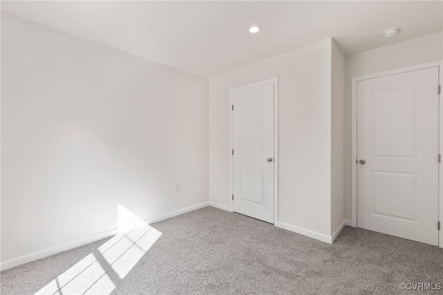 unfurnished bedroom with light colored carpet