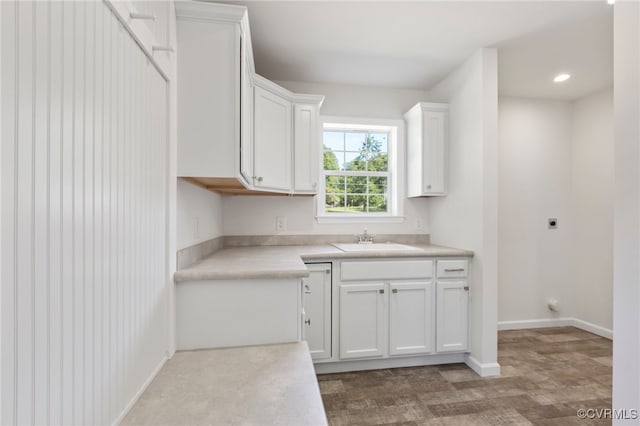 kitchen featuring white cabinets and sink