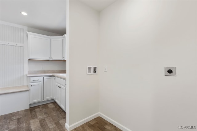 washroom with hookup for a washing machine, dark hardwood / wood-style floors, electric dryer hookup, and cabinets