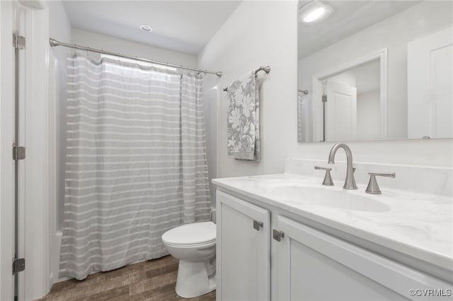 bathroom featuring hardwood / wood-style flooring, vanity, and toilet