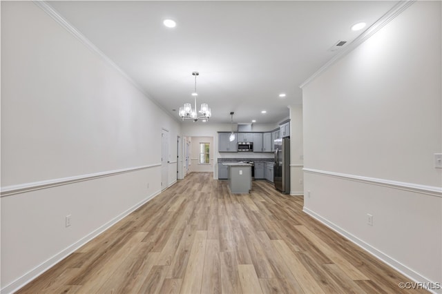 kitchen featuring a kitchen island, stainless steel appliances, light hardwood / wood-style flooring, decorative light fixtures, and ornamental molding