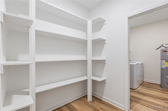 interior space with washer and clothes dryer and electric water heater