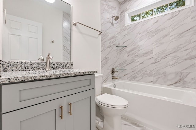 full bathroom with vanity, toilet, and tiled shower / bath