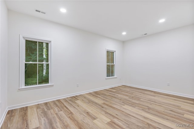 spare room with light hardwood / wood-style floors