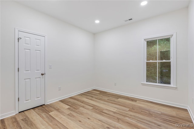 spare room with light hardwood / wood-style flooring