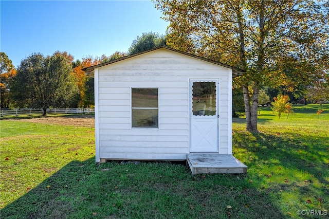 view of outbuilding featuring a yard