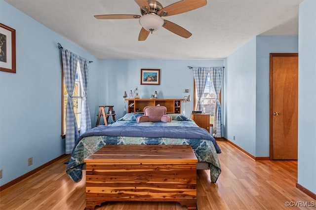 bedroom with light wood-type flooring and ceiling fan