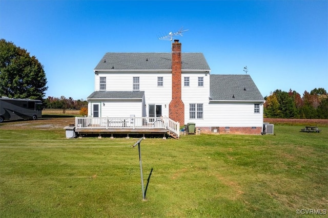 rear view of property featuring central AC, a deck, and a lawn