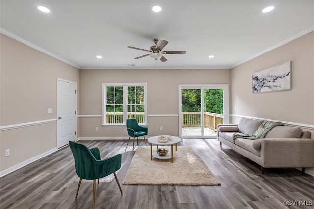 living room featuring ceiling fan, crown molding, plenty of natural light, and dark hardwood / wood-style floors