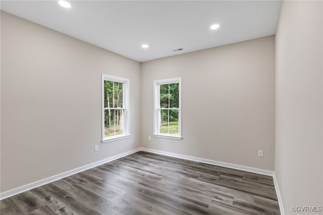 spare room featuring dark hardwood / wood-style floors