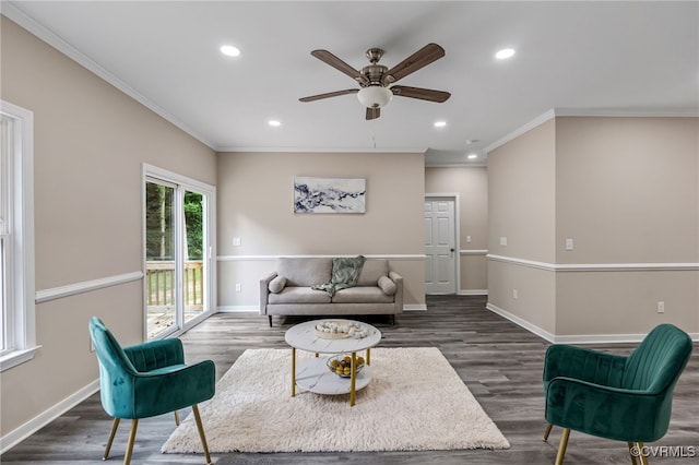 living room with dark hardwood / wood-style floors, crown molding, and ceiling fan