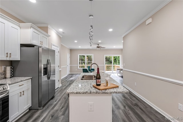 kitchen featuring white cabinets, dark wood-type flooring, sink, pendant lighting, and a center island with sink