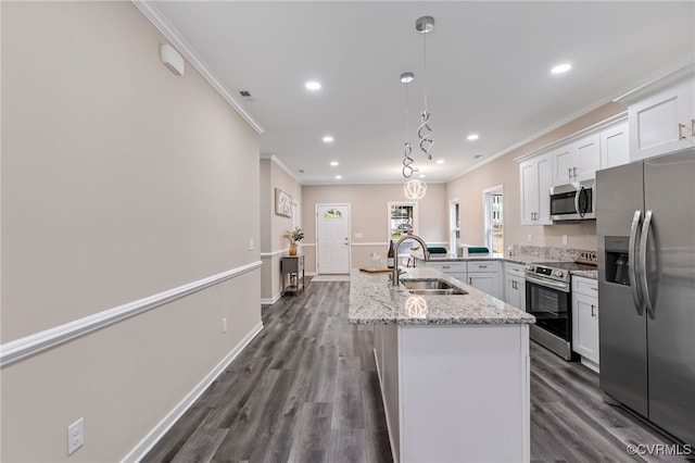 kitchen featuring hanging light fixtures, sink, white cabinetry, appliances with stainless steel finishes, and dark hardwood / wood-style flooring