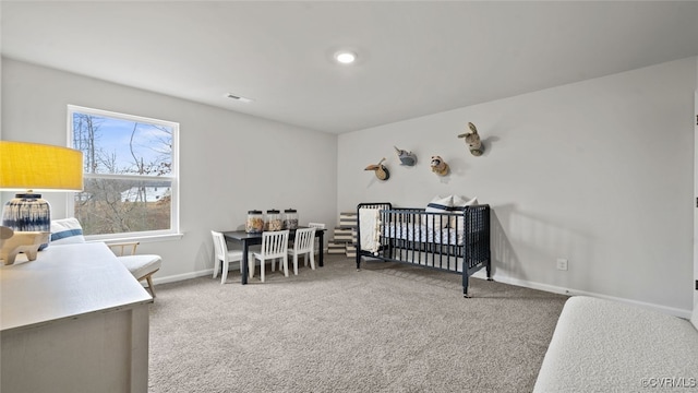 bedroom featuring carpet flooring and a crib