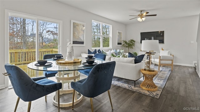 dining space with hardwood / wood-style floors and ceiling fan