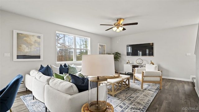 living room with dark hardwood / wood-style flooring and ceiling fan