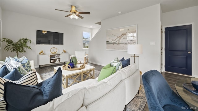 living room featuring dark wood-type flooring and ceiling fan